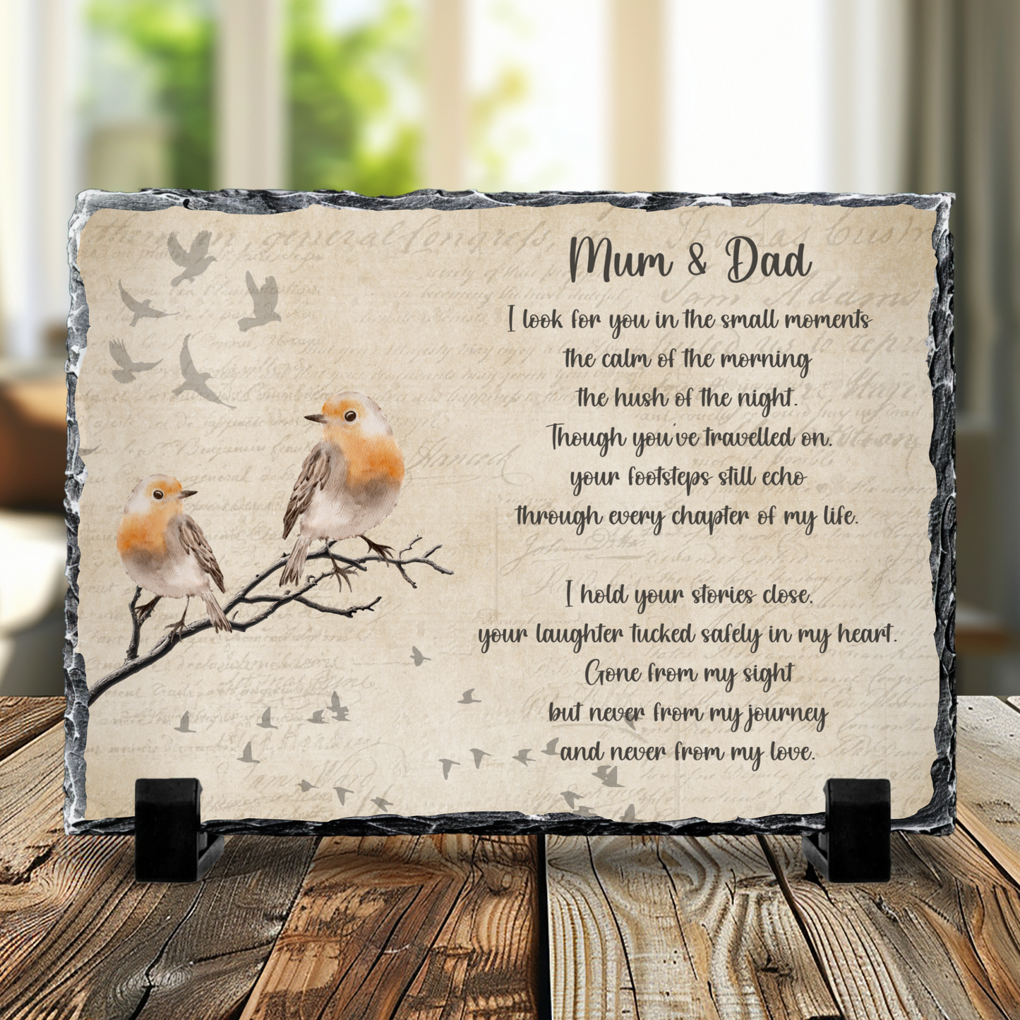 Decorative plaque with birds and a poem on a wooden surface