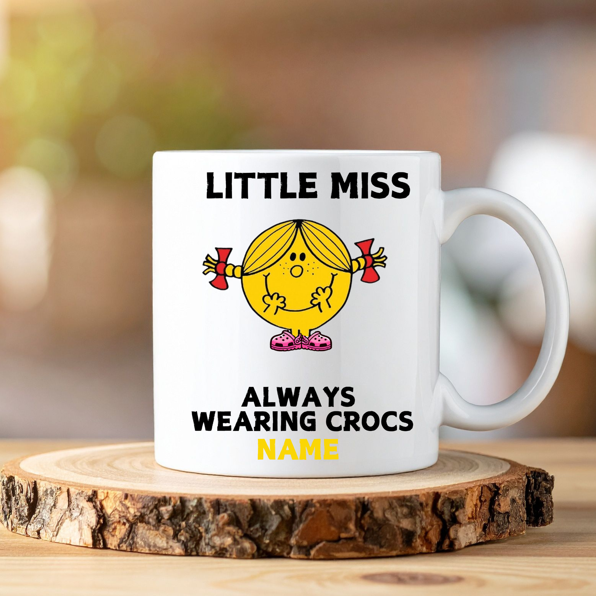 White mug with 'Little Miss' design and text on a wooden coaster
