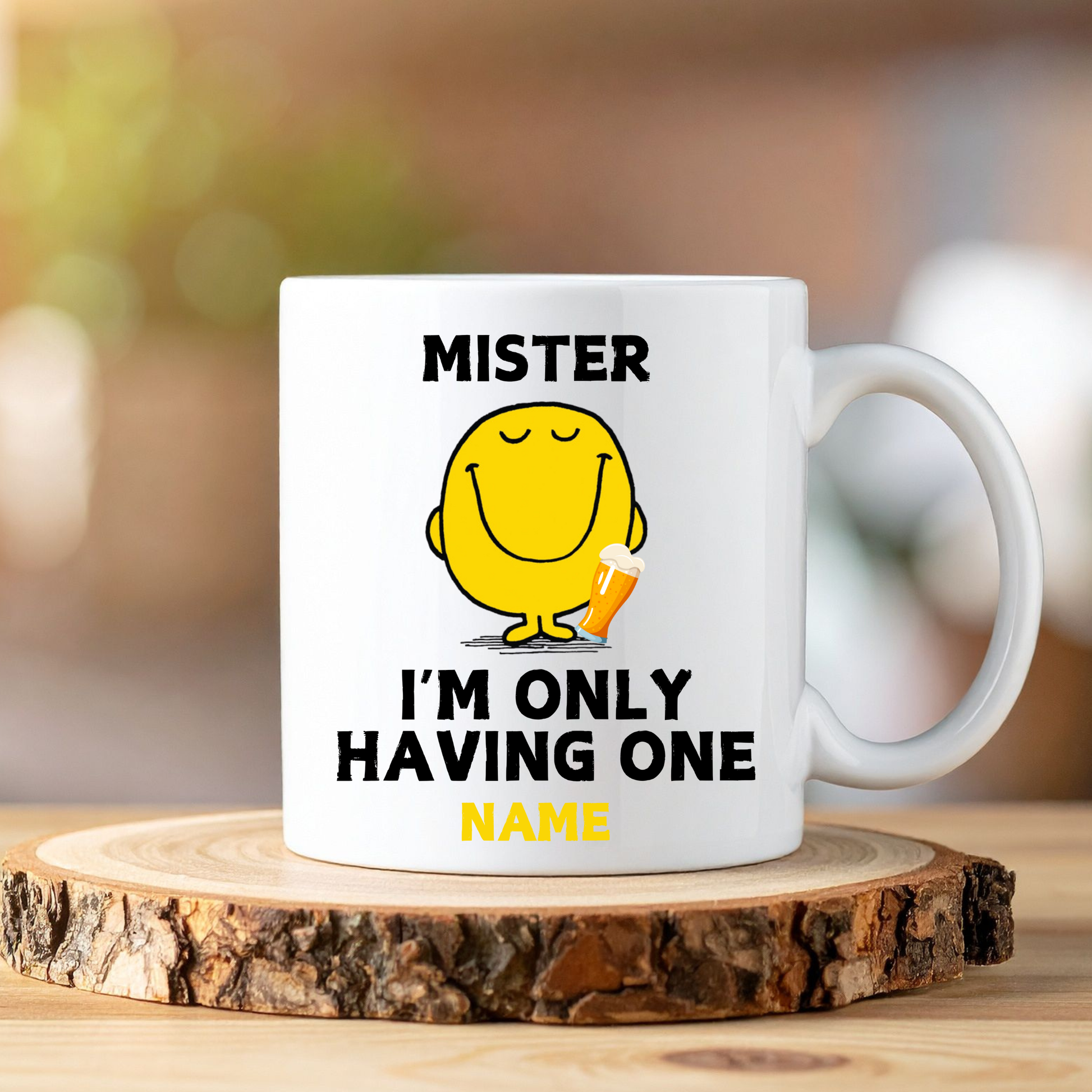 White mug with yellow character and text on a wooden coaster