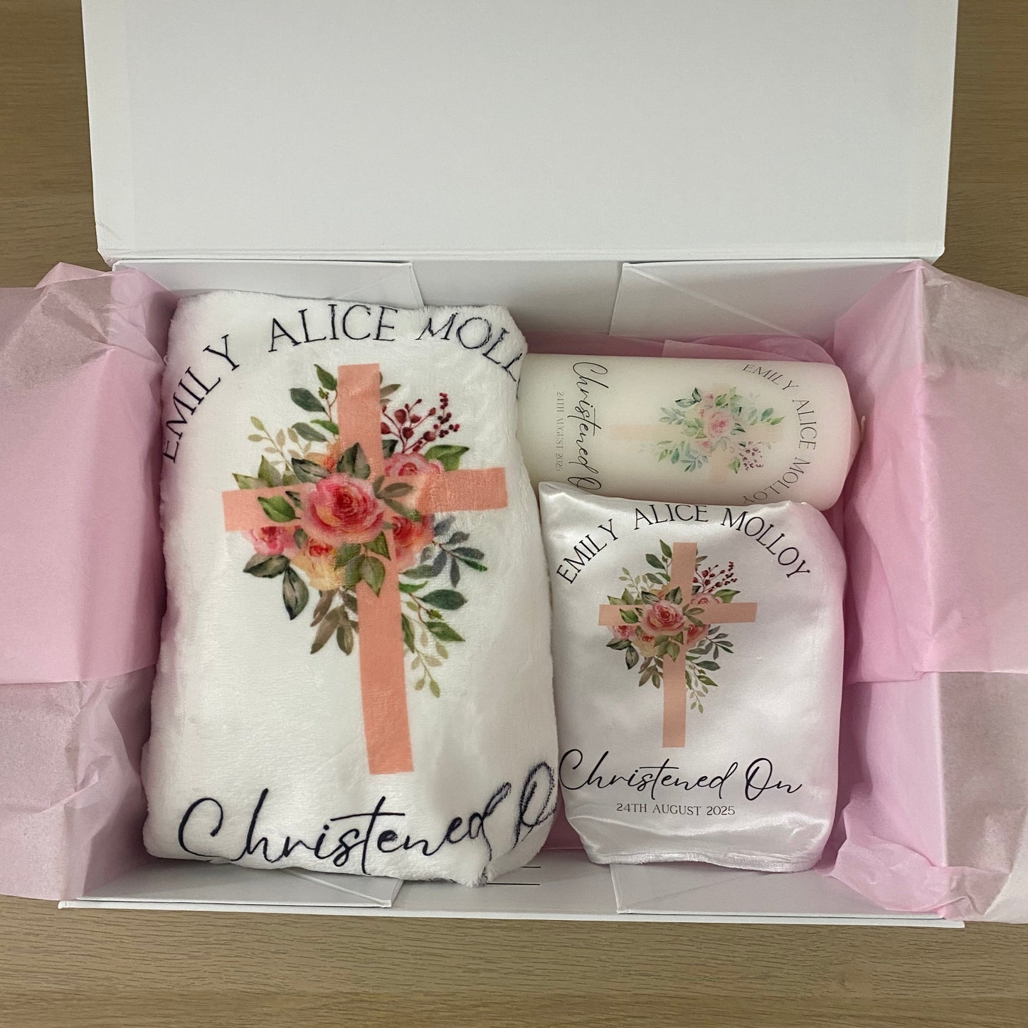 Three white towels with floral designs and text in a box
