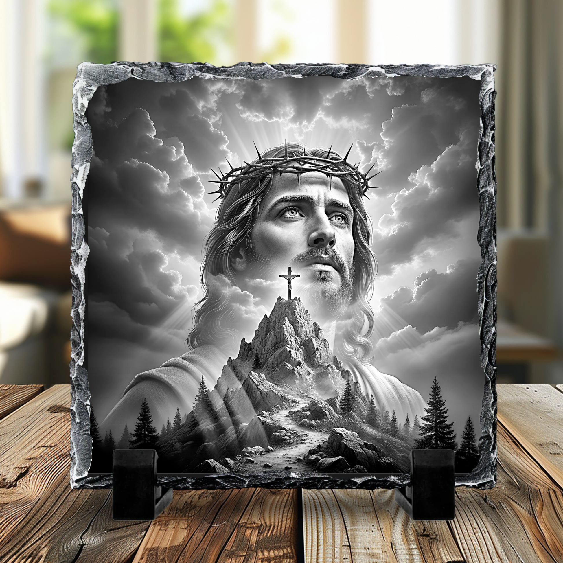 Decorative plaque with a religious design of a crowned figure on a mountain, placed on a wooden surface.